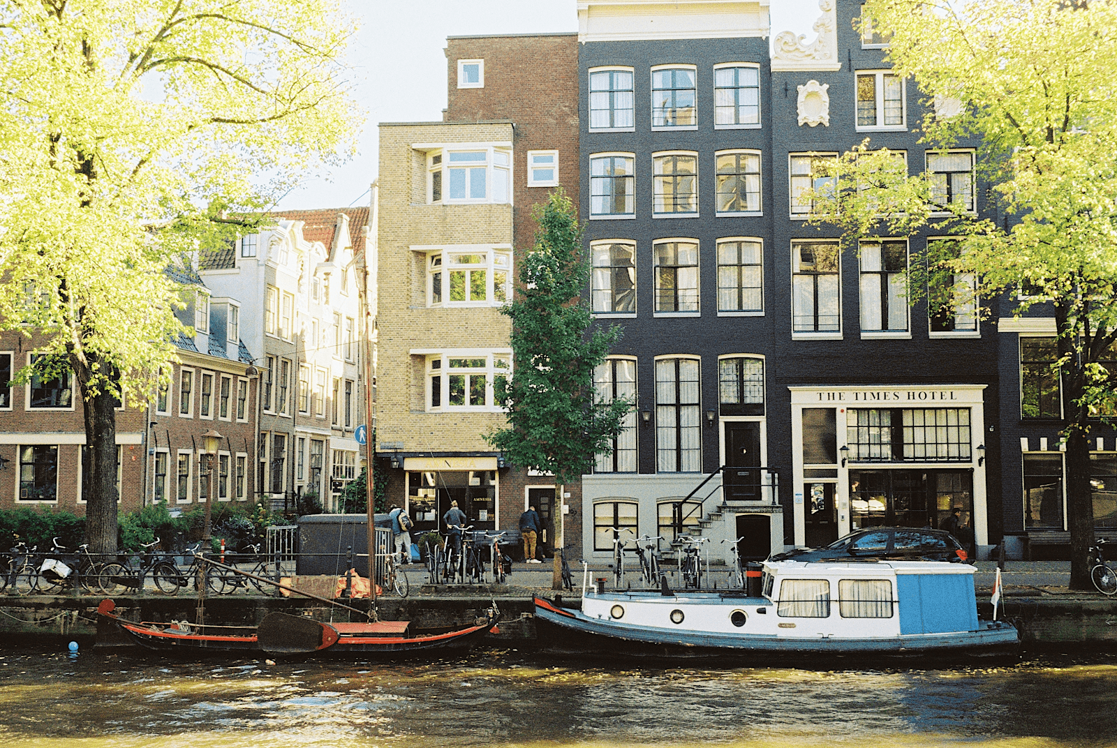 apartment buildings near the canal with small boats