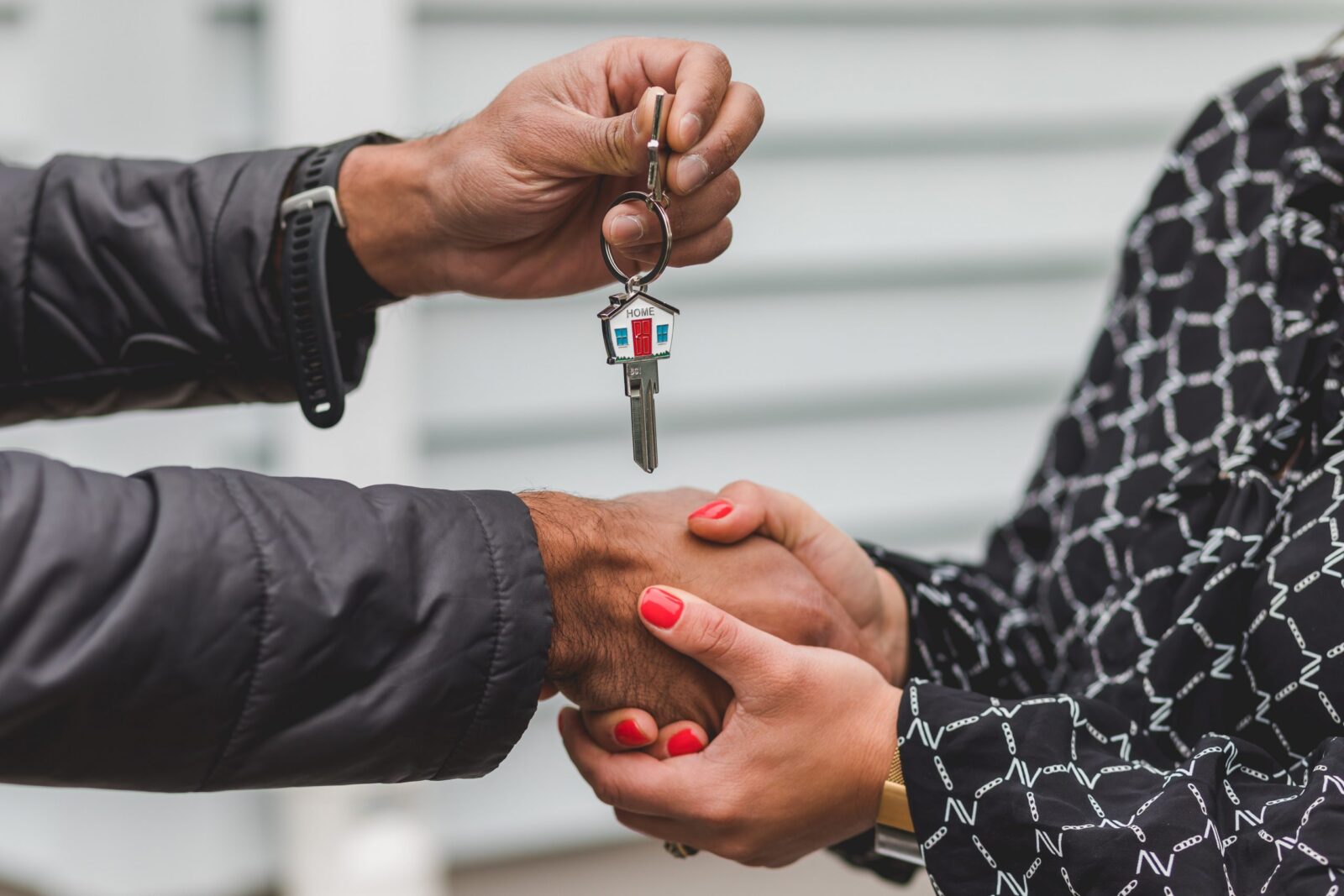A female home buyer getting the keys to the house on closing day