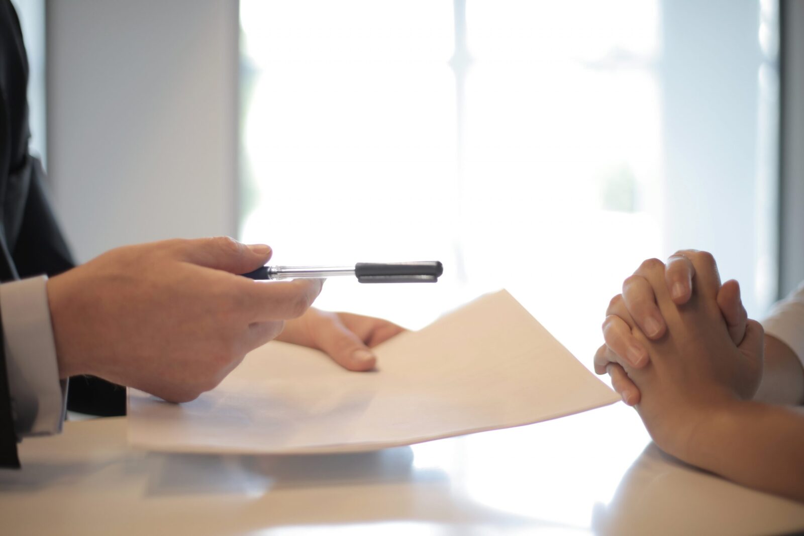 A homebuyer about to sign purchase agreement from the seller's agent