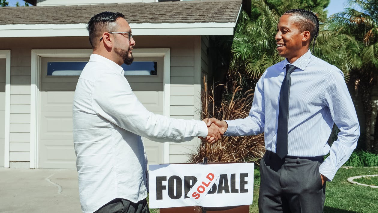 handshake, two men close the sale of the house