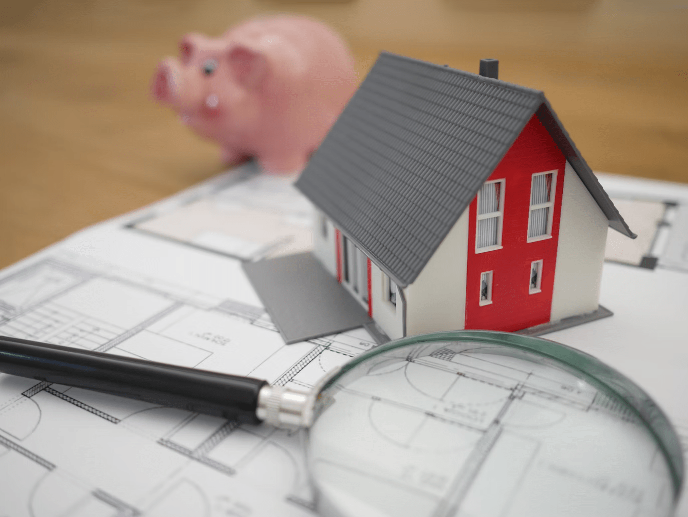 piggy bank in the form of a small pink pig and documents on the table