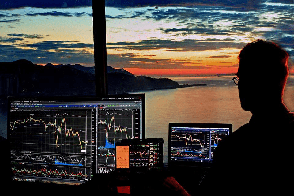 Man looking at graphs of a 10k stock investment