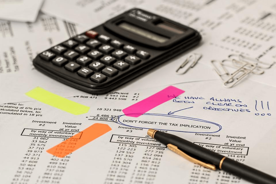 calculator and pen on tax documents