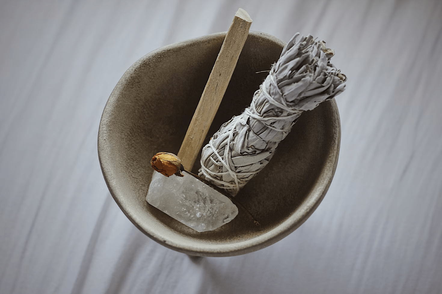 incense and a little rose in a wooden bowl