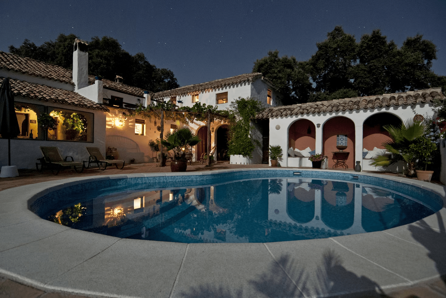 house in the evening light with a large swimming pool