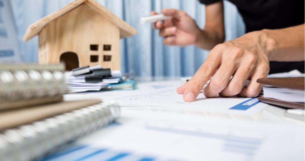 Intending homeowners discussing the home purchase documents with a title agent