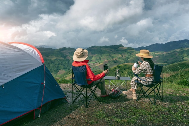 couple tourists enjoying camping mountains