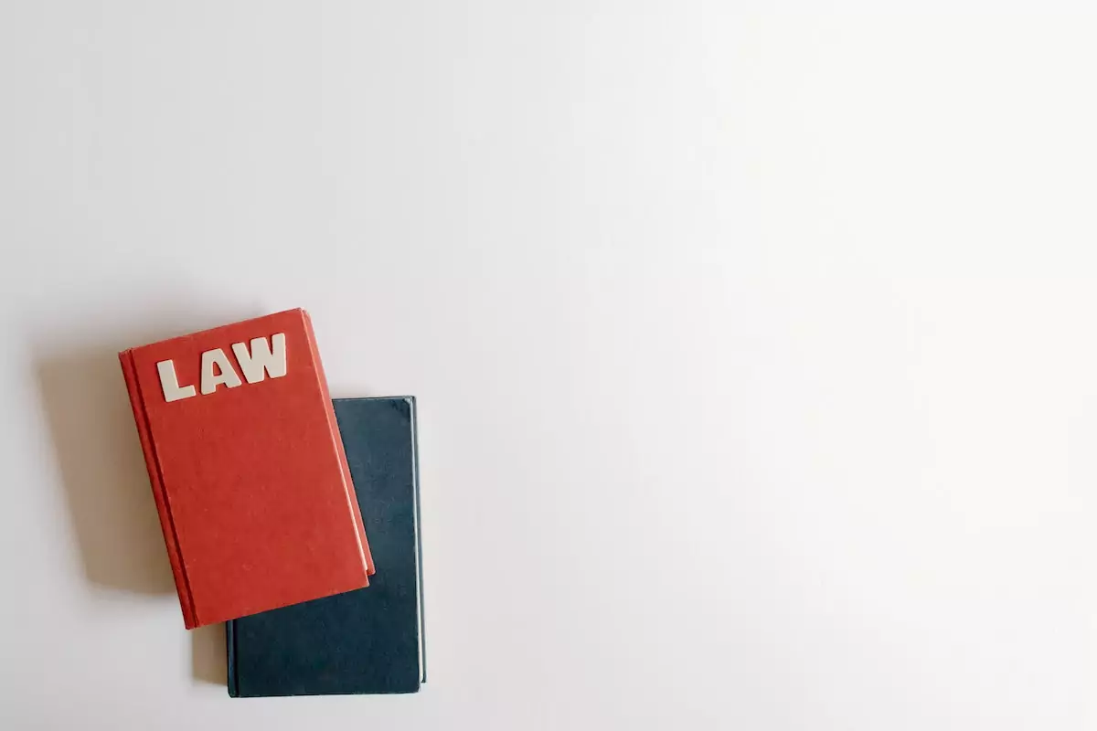 Black and red books on a white background with the top book reading law in white letters.